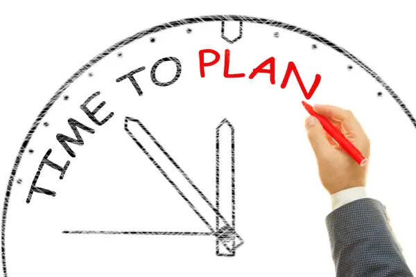 planejamento-de-tempo-efetivo Imagem de uma mão escrevendo o texto time to plan dentro de um relógio analógico